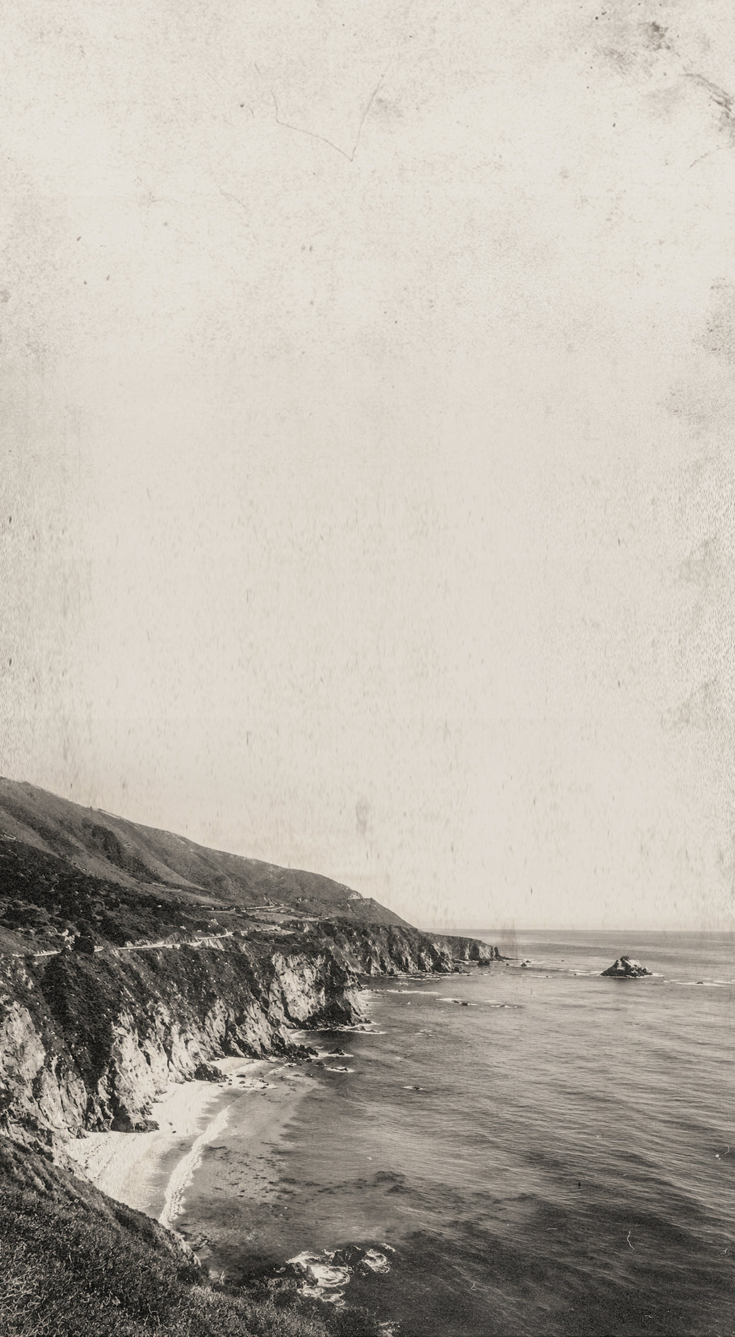 Black and white image of rocky coastal shoreline.