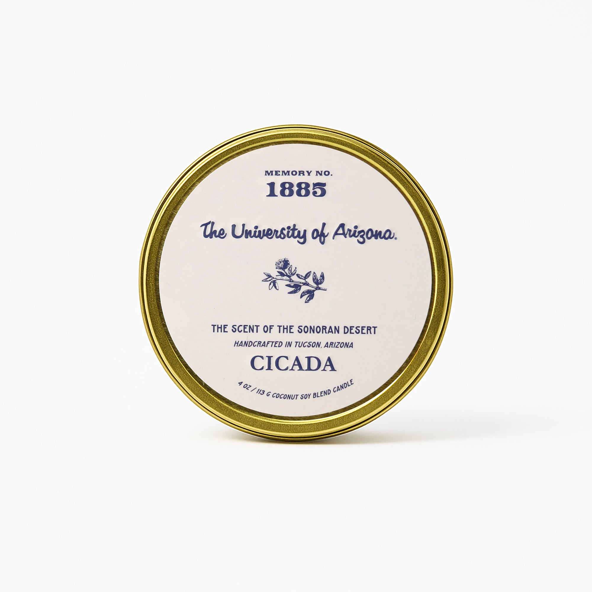 Product image showing the 4 oz gold tin candle with light cream label. Label shows 'The University of Arizona' and 'CICADA' logos on it. Label also shows No. 1885 scent name on it. Image has a white background