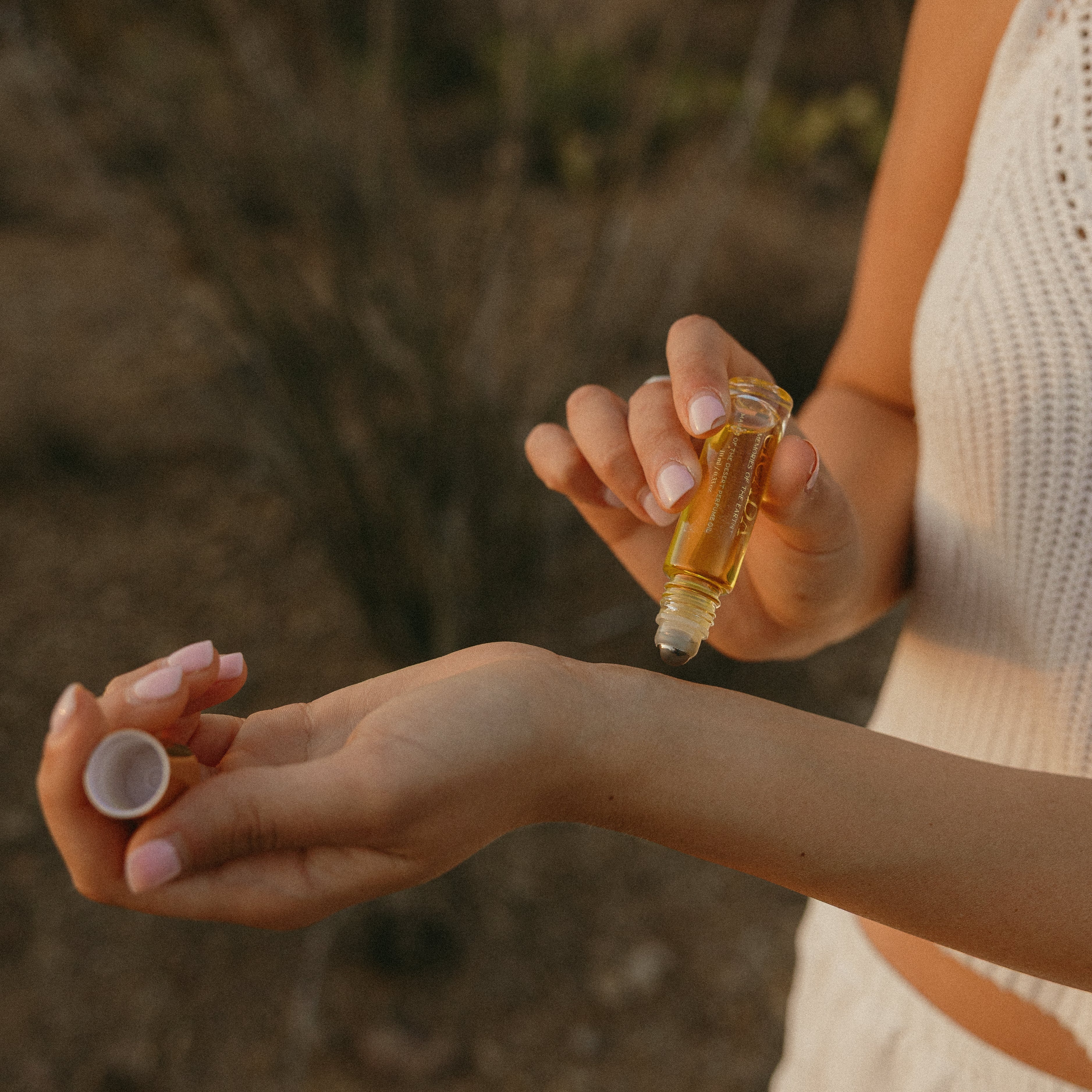 Lifestyle image of person applying roller ball to wrists.
