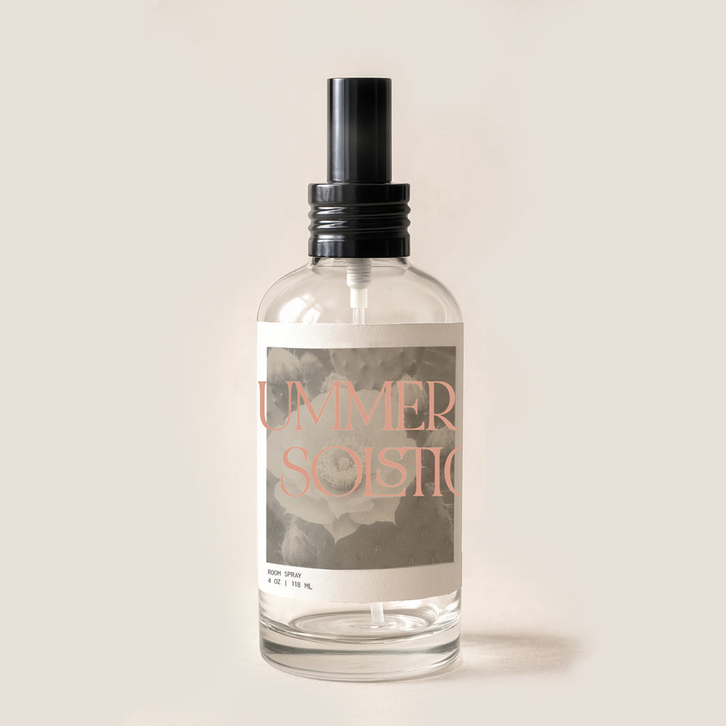 Clear room spray bottle with label that reads summer Solstice. Bottle has black pump